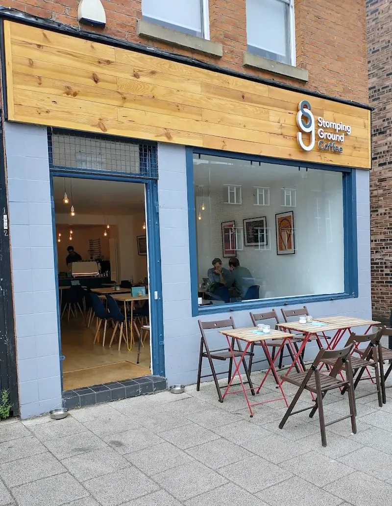The current shopfront on Shaw Road, wood-clad fascia and pavement tables